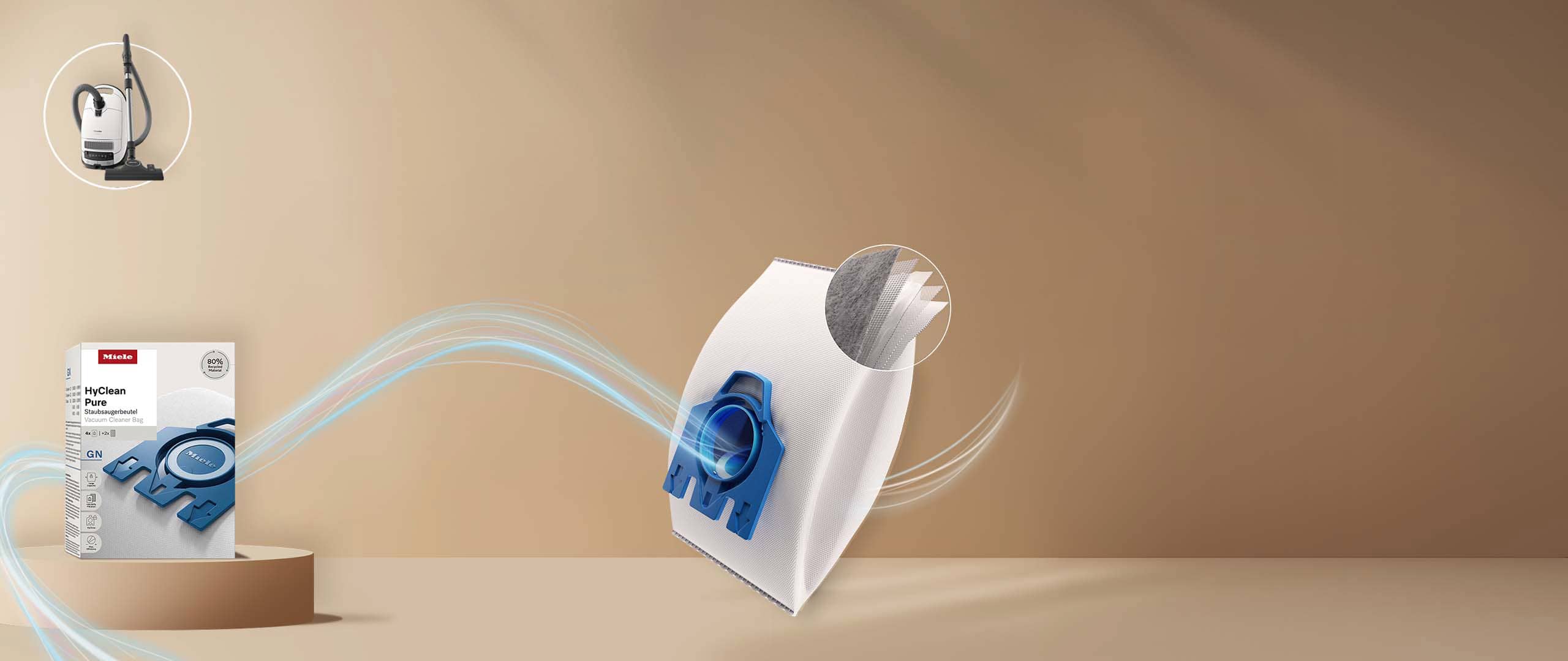 Miele HyClean vacuum cleaner bag with blue fitting, airflow swirls, and material layers inset, plus product box and vacuum. Miele HyClean vacuum cleaner bag with blue fitting, airflow swirls, and material layers inset, plus product box and vacuum.