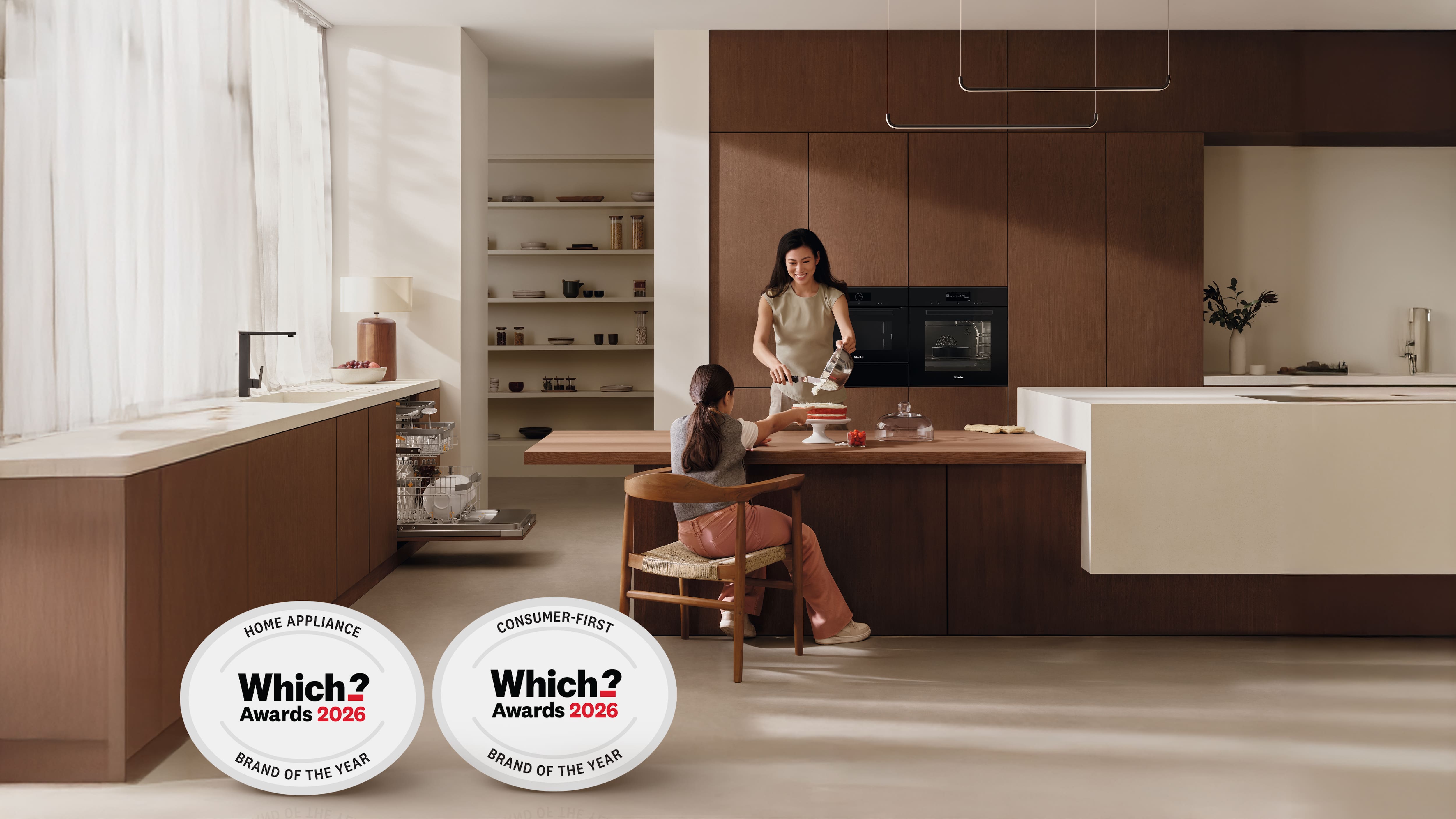 Woman and daughter baking in a modern kitchen with Miele appliances. Woman and daughter baking in a modern kitchen with Miele appliances.