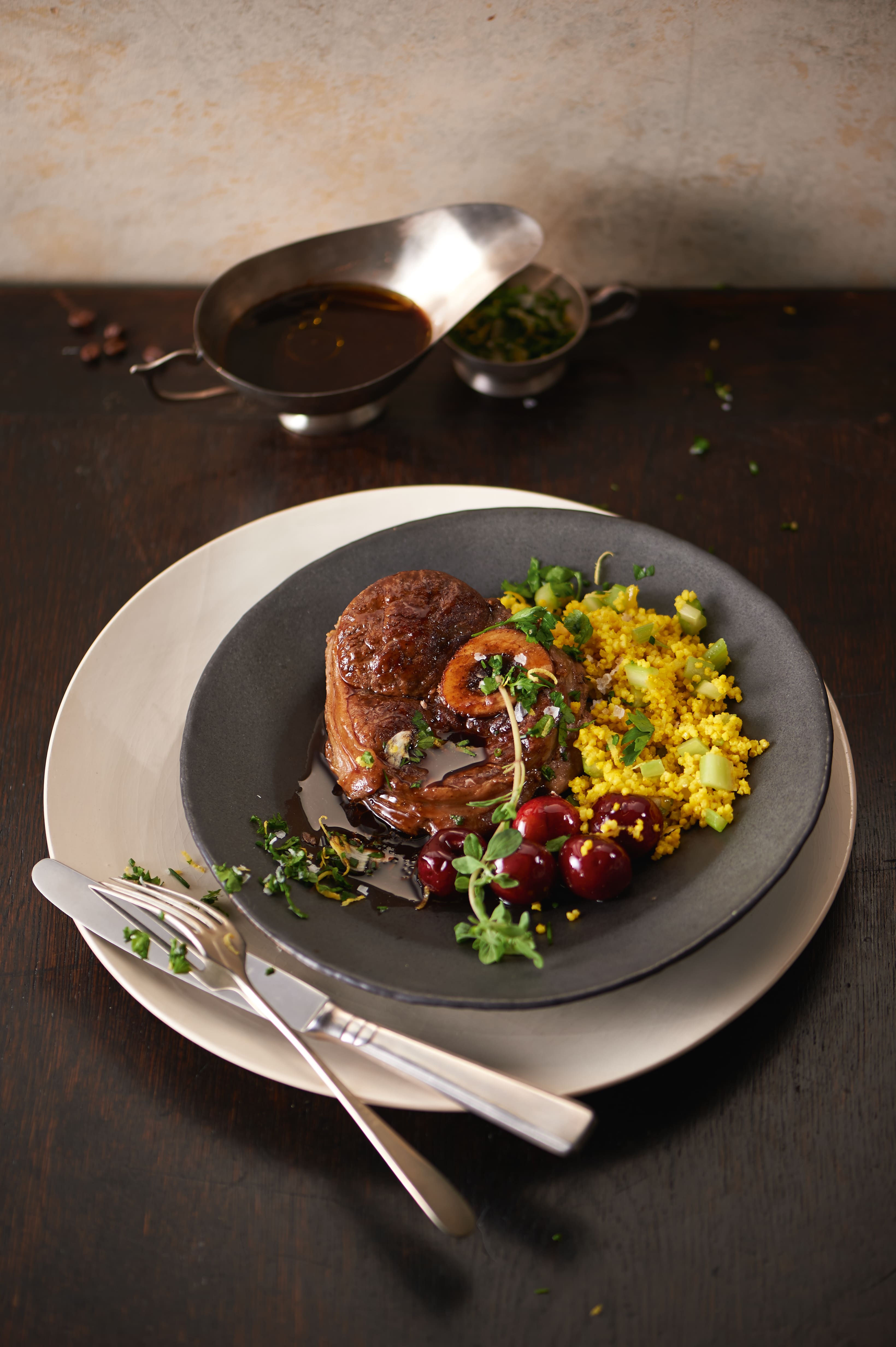 Braised beef shank with marrow in red wine sauce, served with herbed couscous and fresh cherries. Braised beef shank with marrow in red wine sauce, served with herbed couscous and fresh cherries.