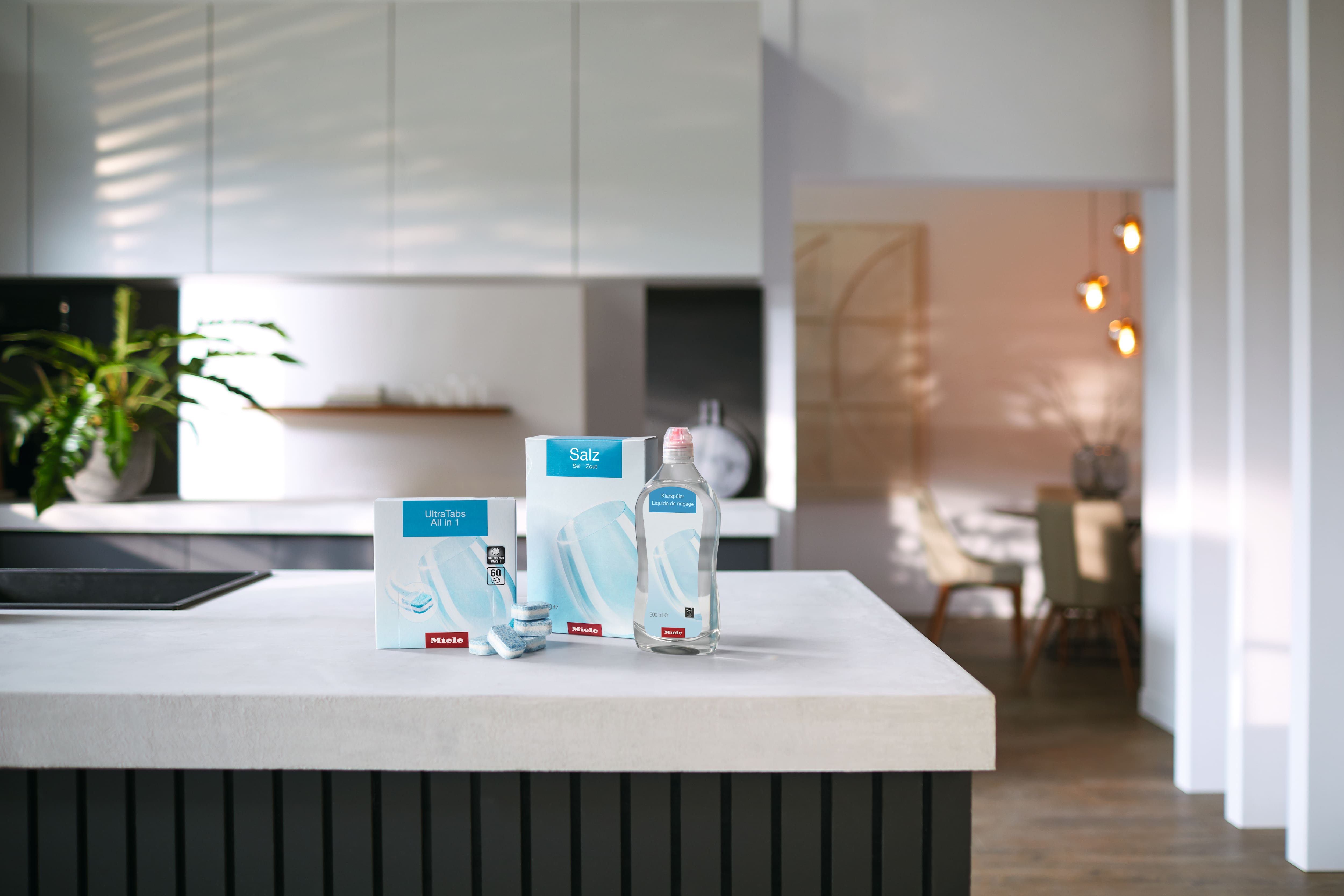Miele dishwasher essentials: UltraTabs, Salz dishwasher salt, and rinse aid on a modern kitchen counter.