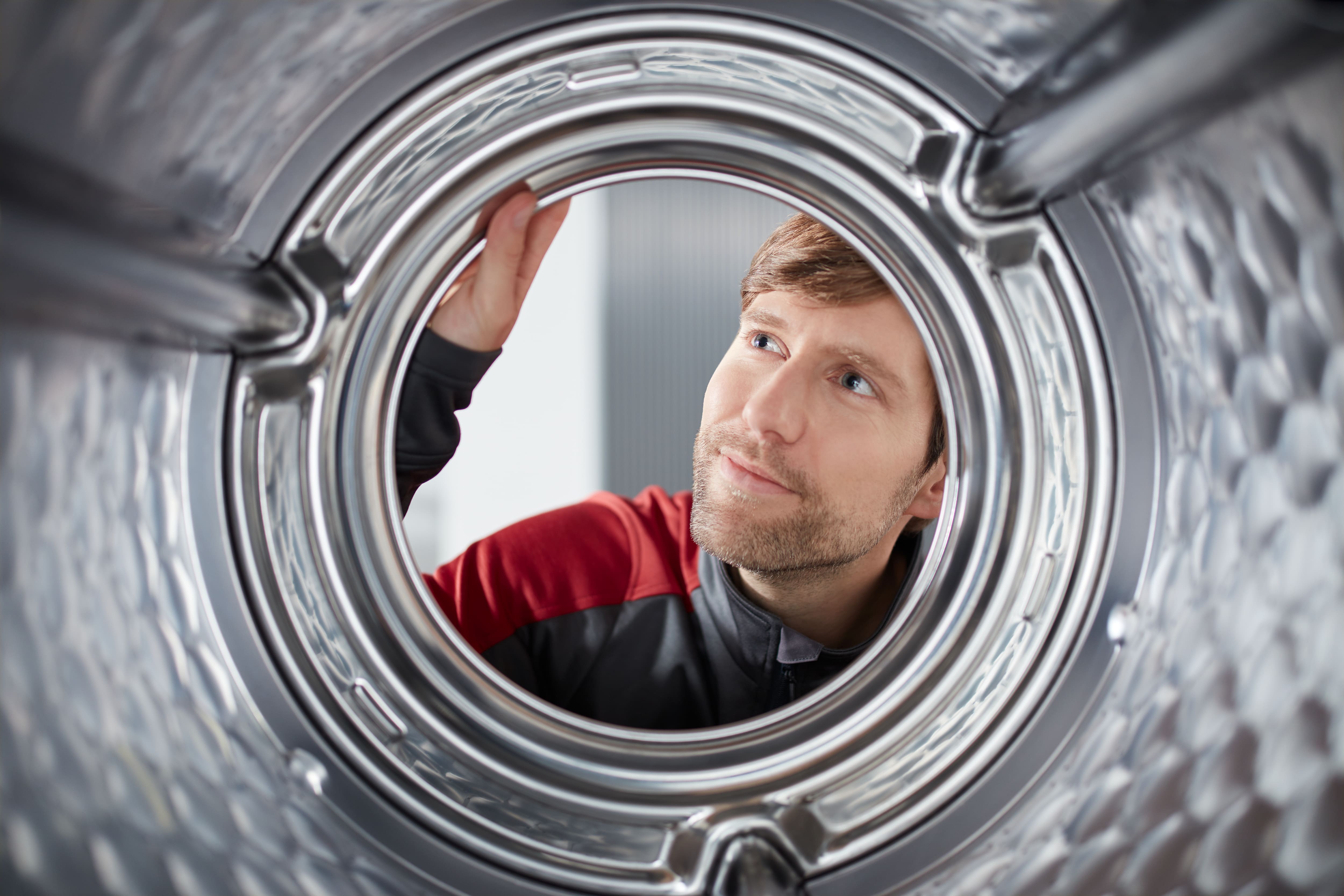 Technician checking a Miele washing machine Technician checking a Miele washing machine