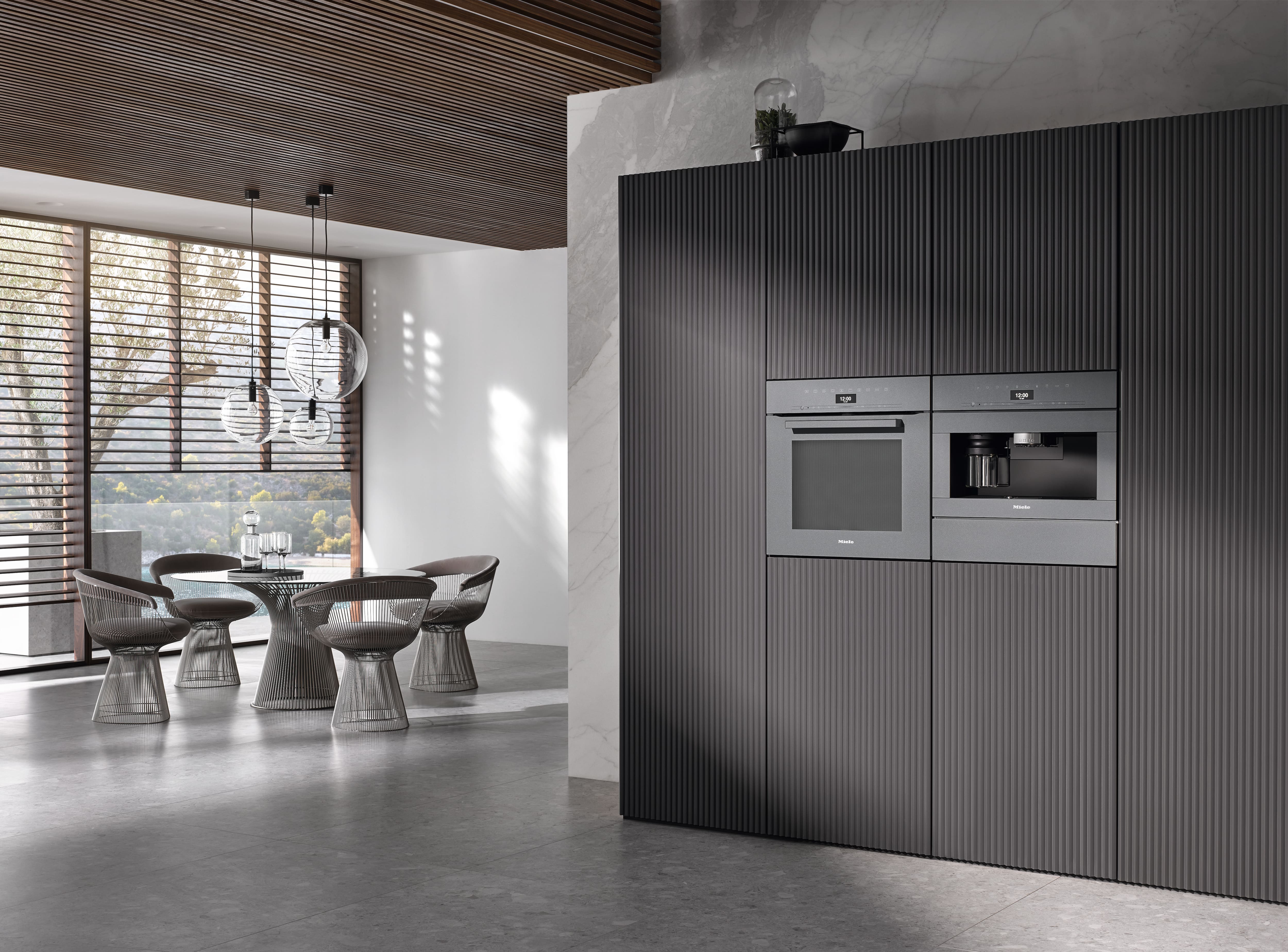 Sleek modern kitchen with built-in espresso machine and marble sink; separate wooden wall shelf with minimalist decor.