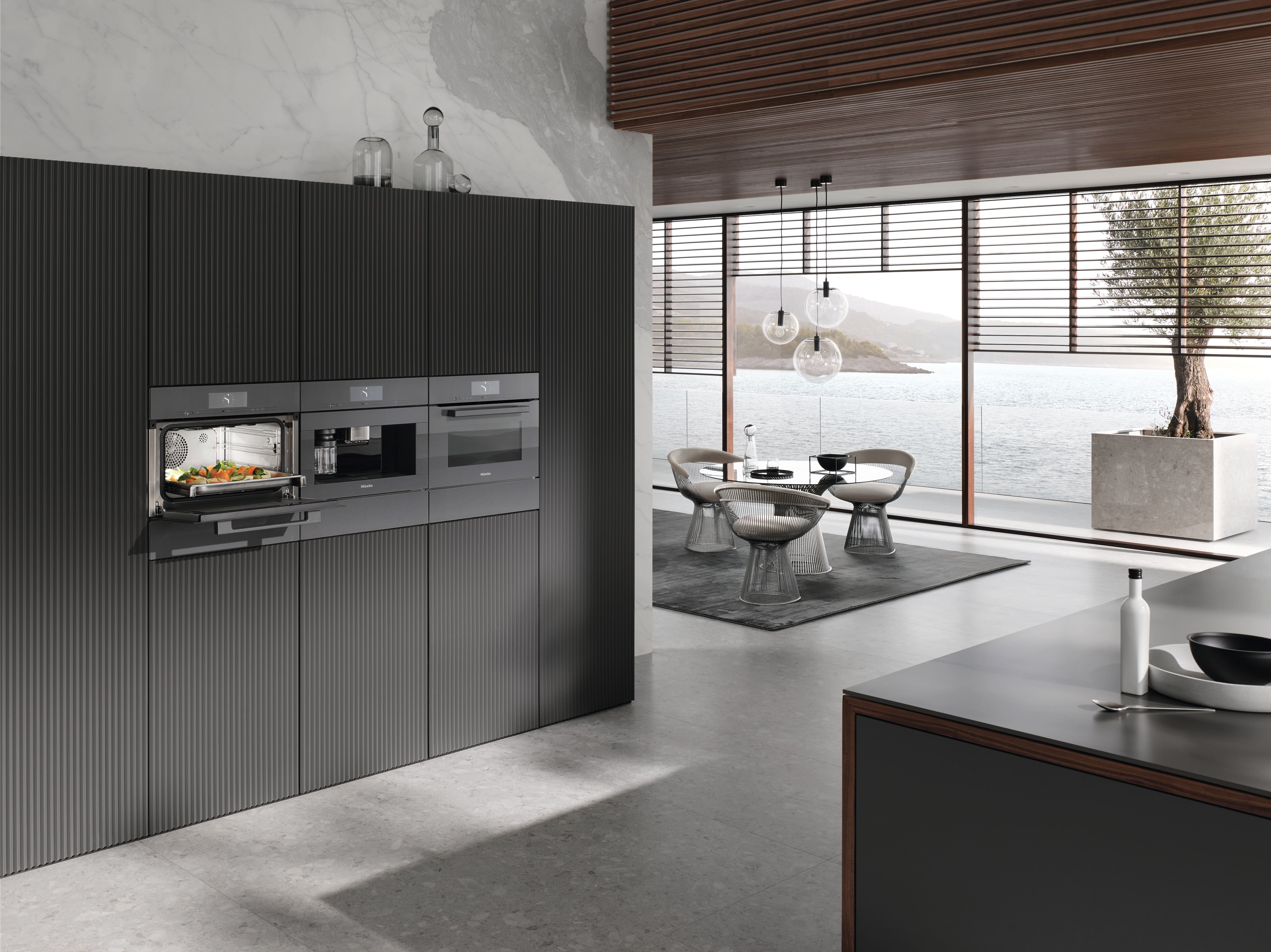 a dark kitchen with Miele appliances a dark kitchen with Miele appliances