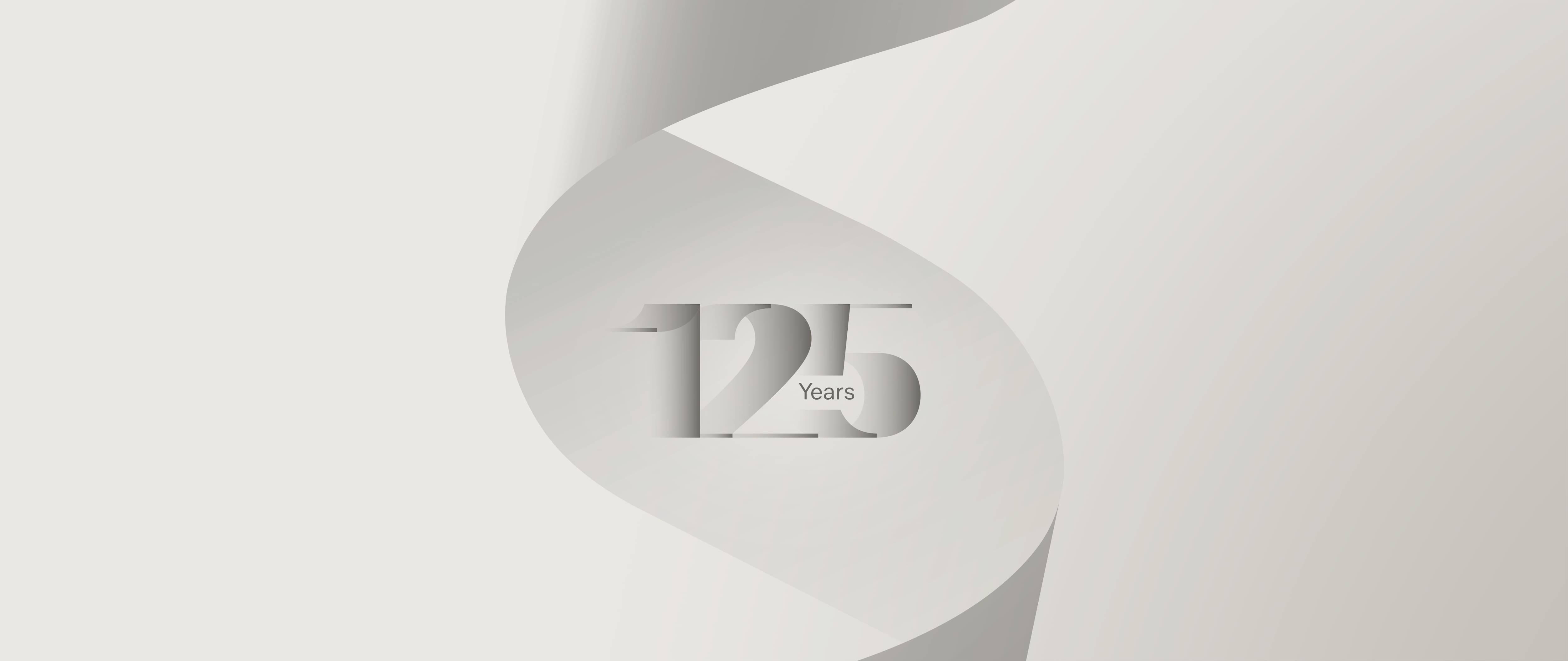 Minimalist anniversary graphic featuring “125 Years” carved into a curling paper ribbon in soft gray gradients. Minimalist anniversary graphic featuring “125 Years” carved into a curling paper ribbon in soft gray gradients.