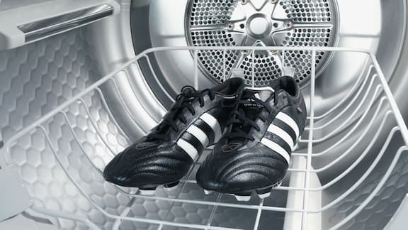 Football boots inside washing machine drum