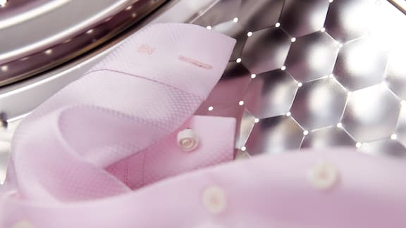 Pink clothing in washing machine drum