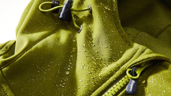 Lime green rain coat with mist drops