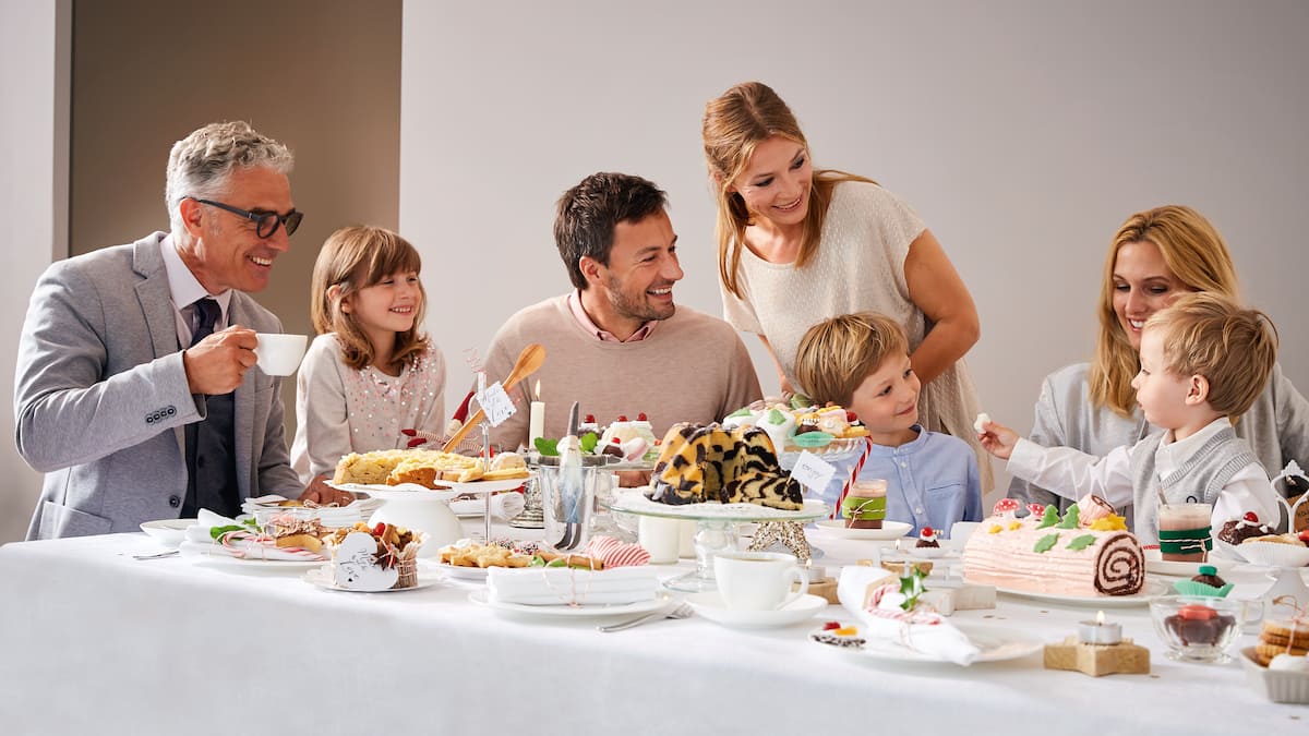 Large family at a fully set dining table.