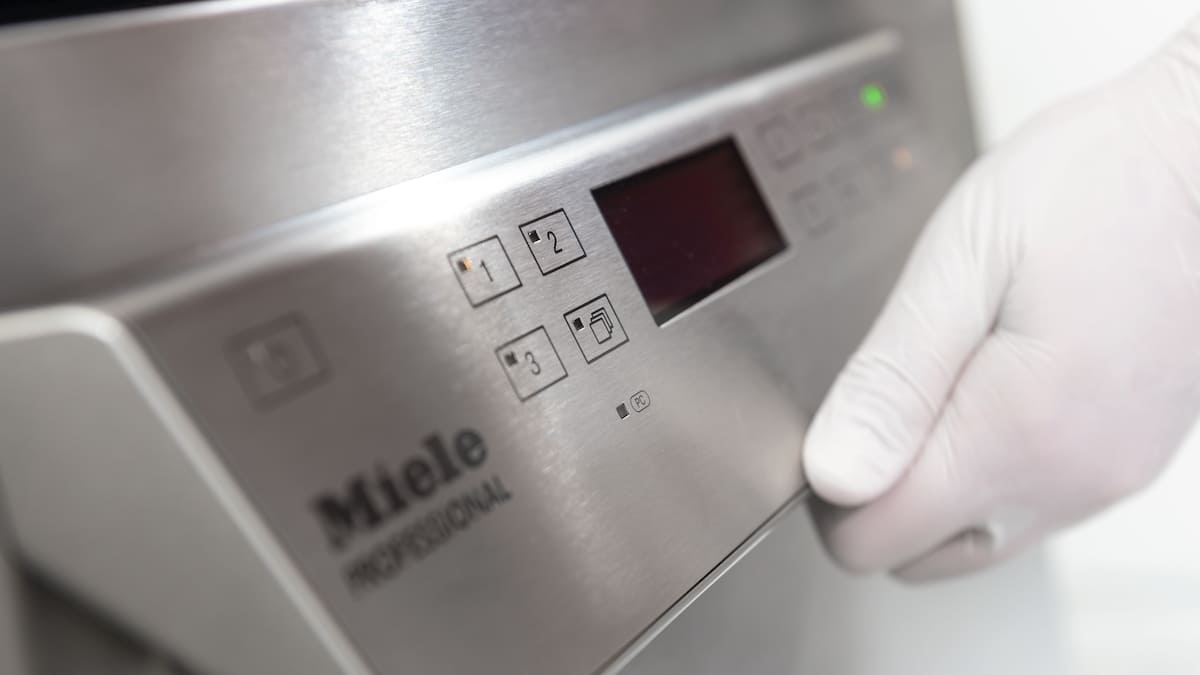 Dental washer close-up with hand opening it