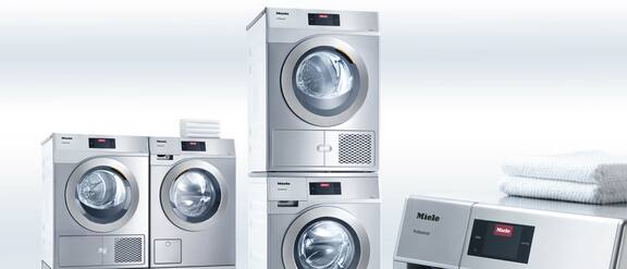 Packshot of 5 professional commercial washing machines.