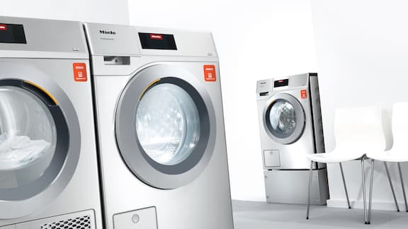 Washing machines and tumble dryers with appWash in a washroom.