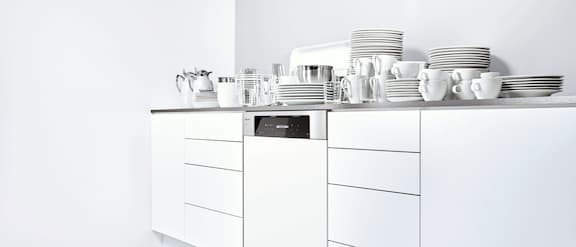 Dishwasher in the kitchenette with clean crockery.