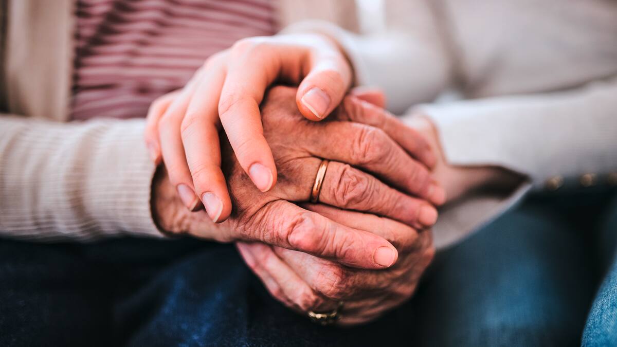 Carer holding hands with a resident