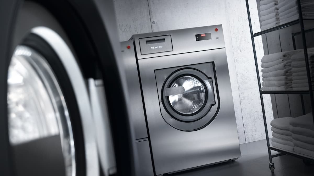Imagem de máquina de lavar roupa e secador industriais Miele Professional com cores dessaturadas