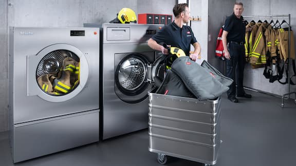 Two firefighters in the laundry room