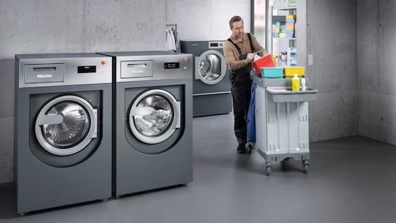 Contract cleaner enters laundry room with mobile unit