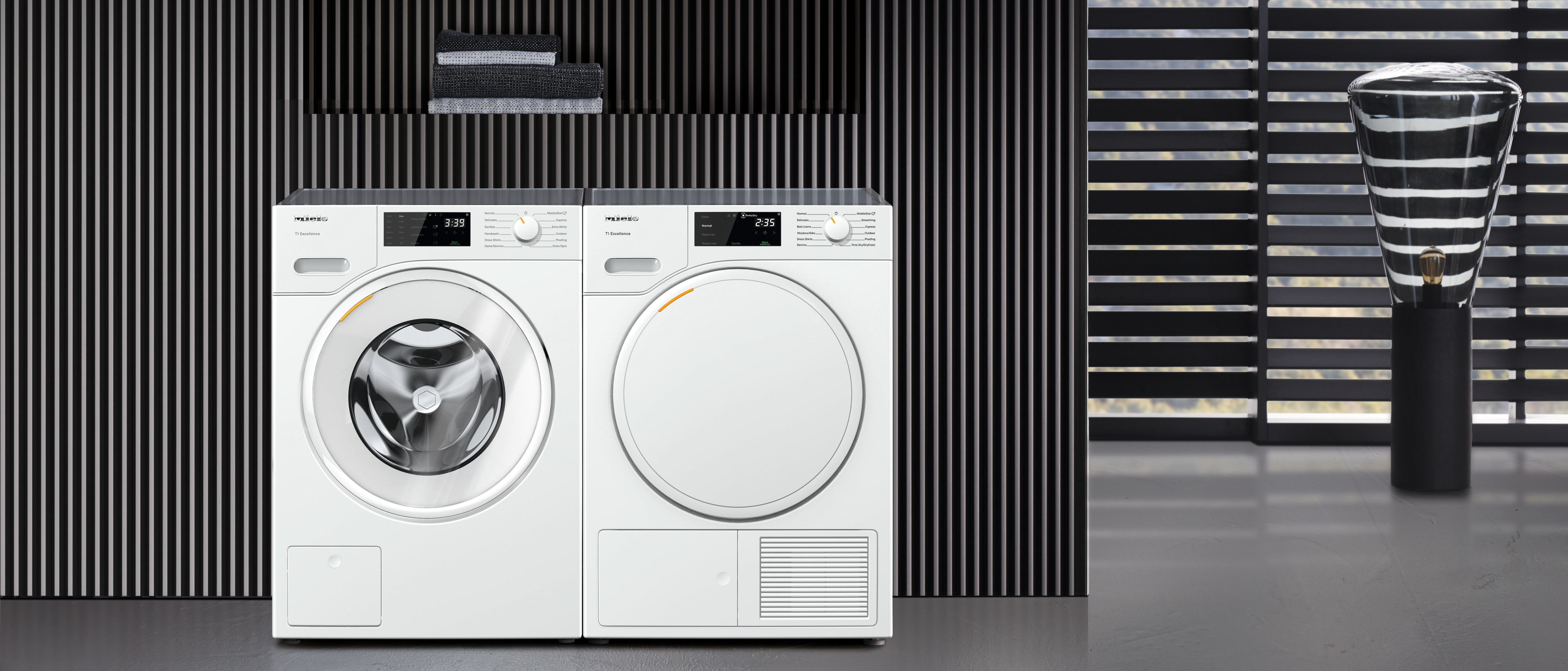 laundry room with Miele washing machine and dryer