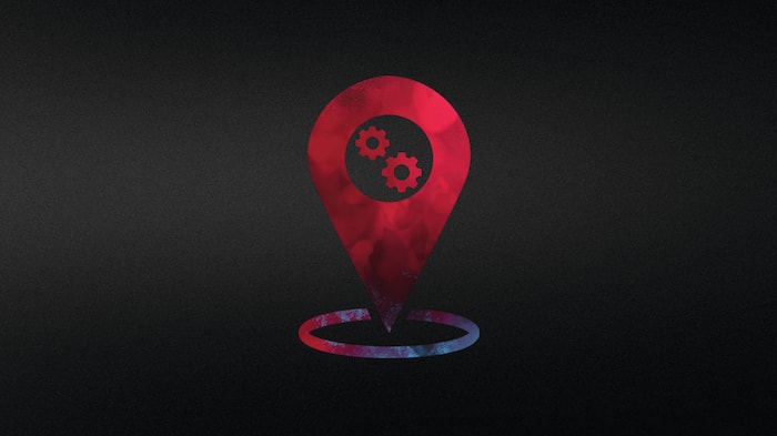 Abstract symbol in black and red representing a location icon