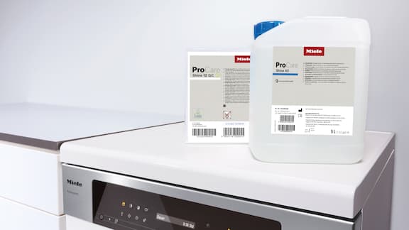 Cleaning chemistry is on top of a dishwasher.