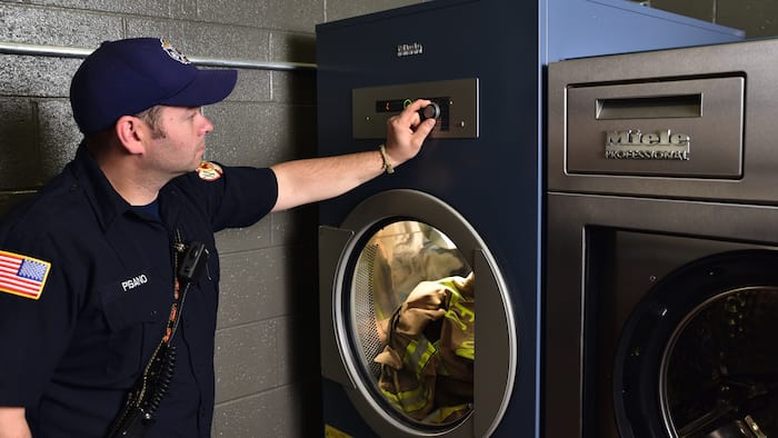 A fireman loads a special insert for breathing masks and air regulators.