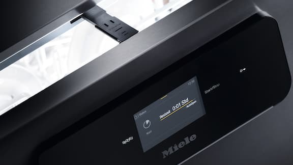Automatisk åpnet Miele Professional MasterLine oppvaskmaskin med touchdisplay og visning med timer