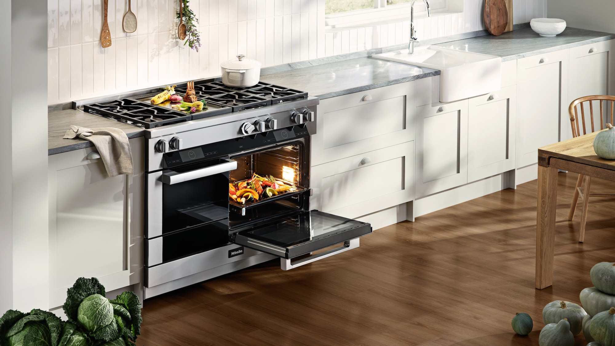 Miele-Range-with-roasted-vegetables-inside-oven-and-ontop-of-cooktop