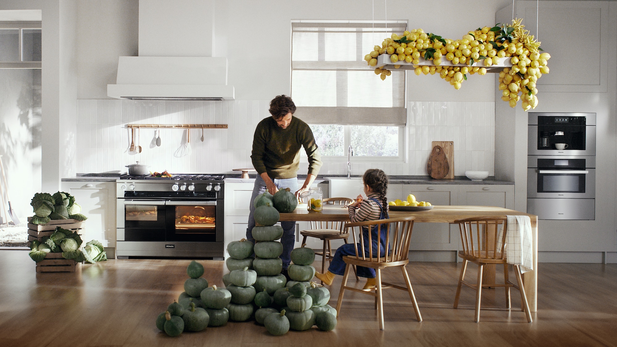 Father cooking for daughter in a Miele Kitchen