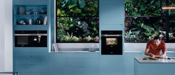 In a kitchen a guy is assembling a plate