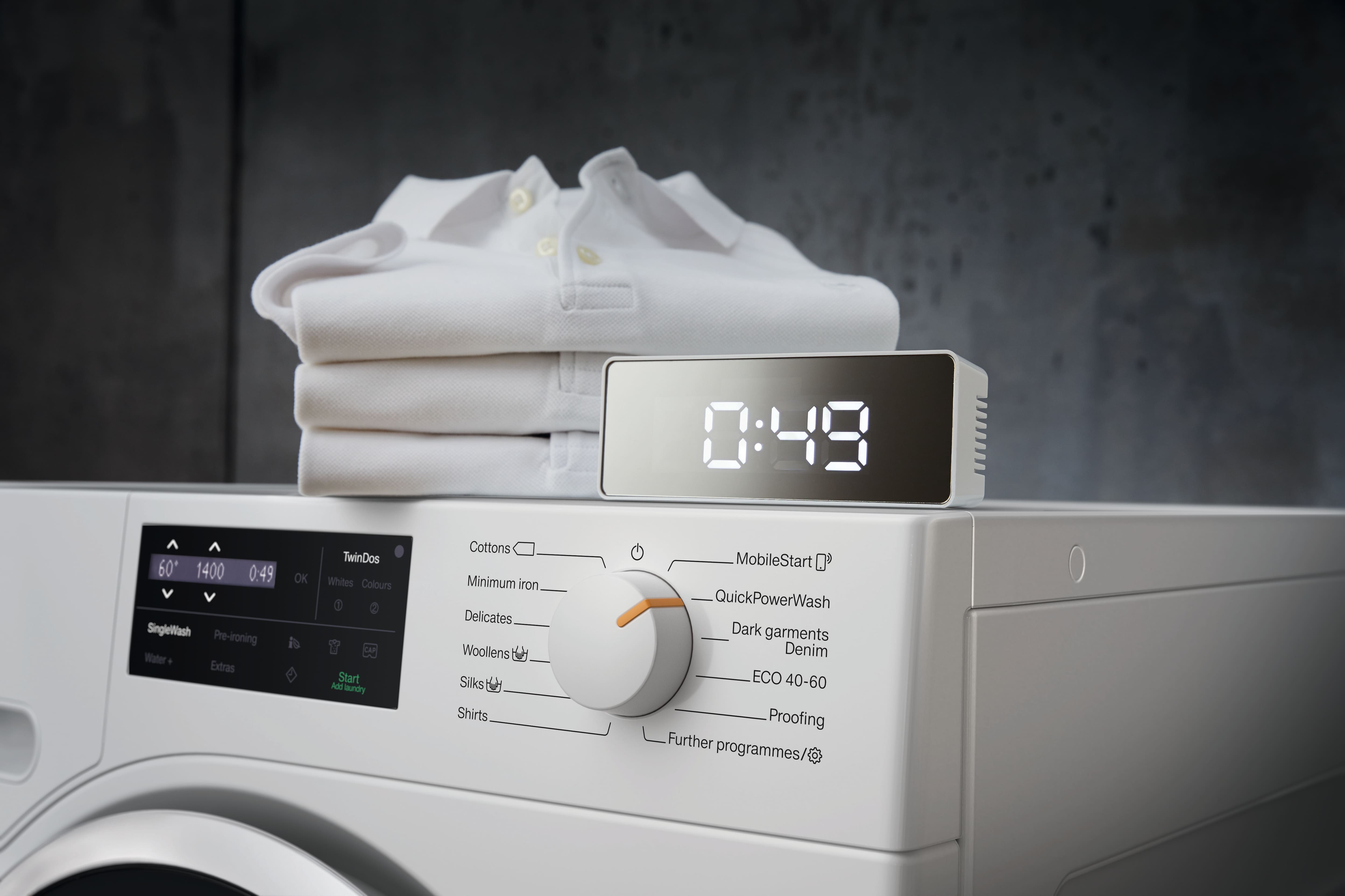 Miele washing machine with a graphic display on its left displaying 49 minutes timer