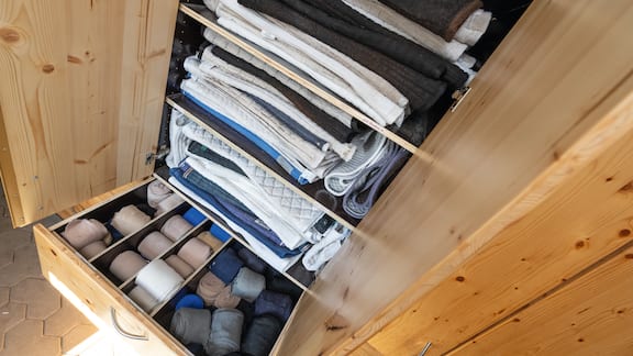 The cabinets in the tack room are packed full to the brim with saddle pads and bandages.