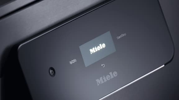 The modern touch display of a Miele Professional dishwasher is shown