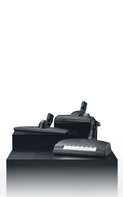 Three floorheads of Miele Vacuum Cleaners displayed on a pedestal
