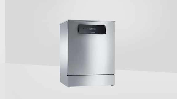 Miele Professional MasterLine dishwasher stands in an empty room with white walls 