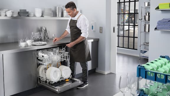 Symbolic image of commercial kitchen with various dishwashers from Miele.