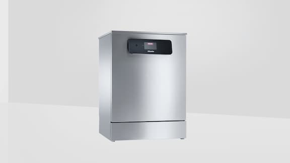 Miele Professional MasterLine dishwasher stands in an empty room with white walls 