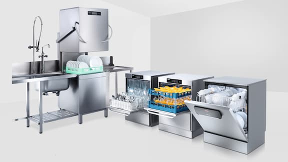 A throughput dishwasher, two tank dishwasher and a freshwater dishwasher in a row on a white background 