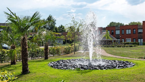 The outdoor area of the Elim retirement home in the Netherlands. A fountain in the centre.