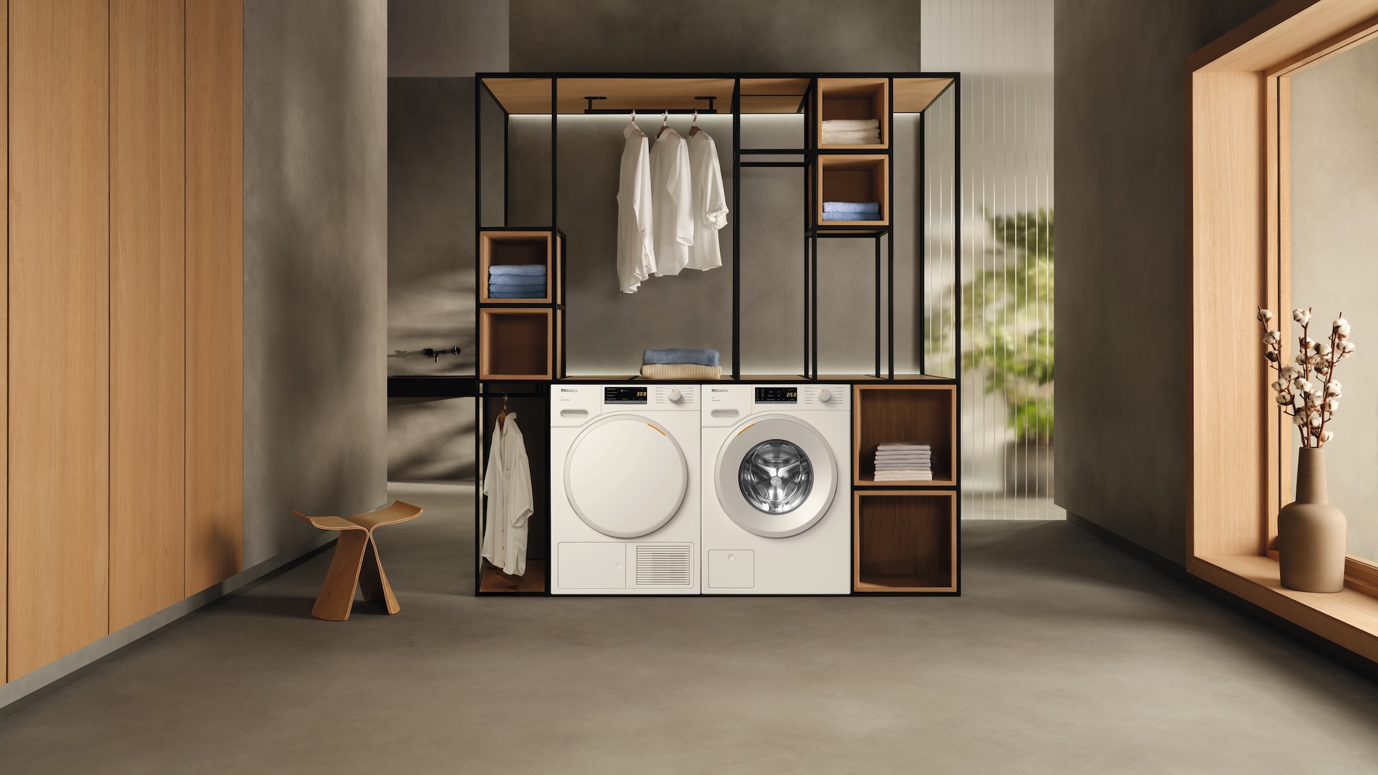 laundry room with Miele washing machine and Miele tumble dryer