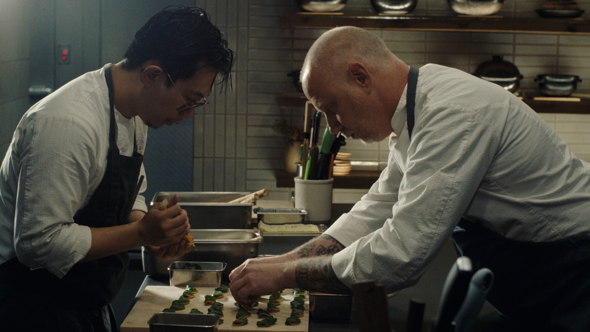 Chef Kyle cooking with another chef in a kitchen