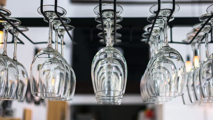 Wine glasses hanging from a rack