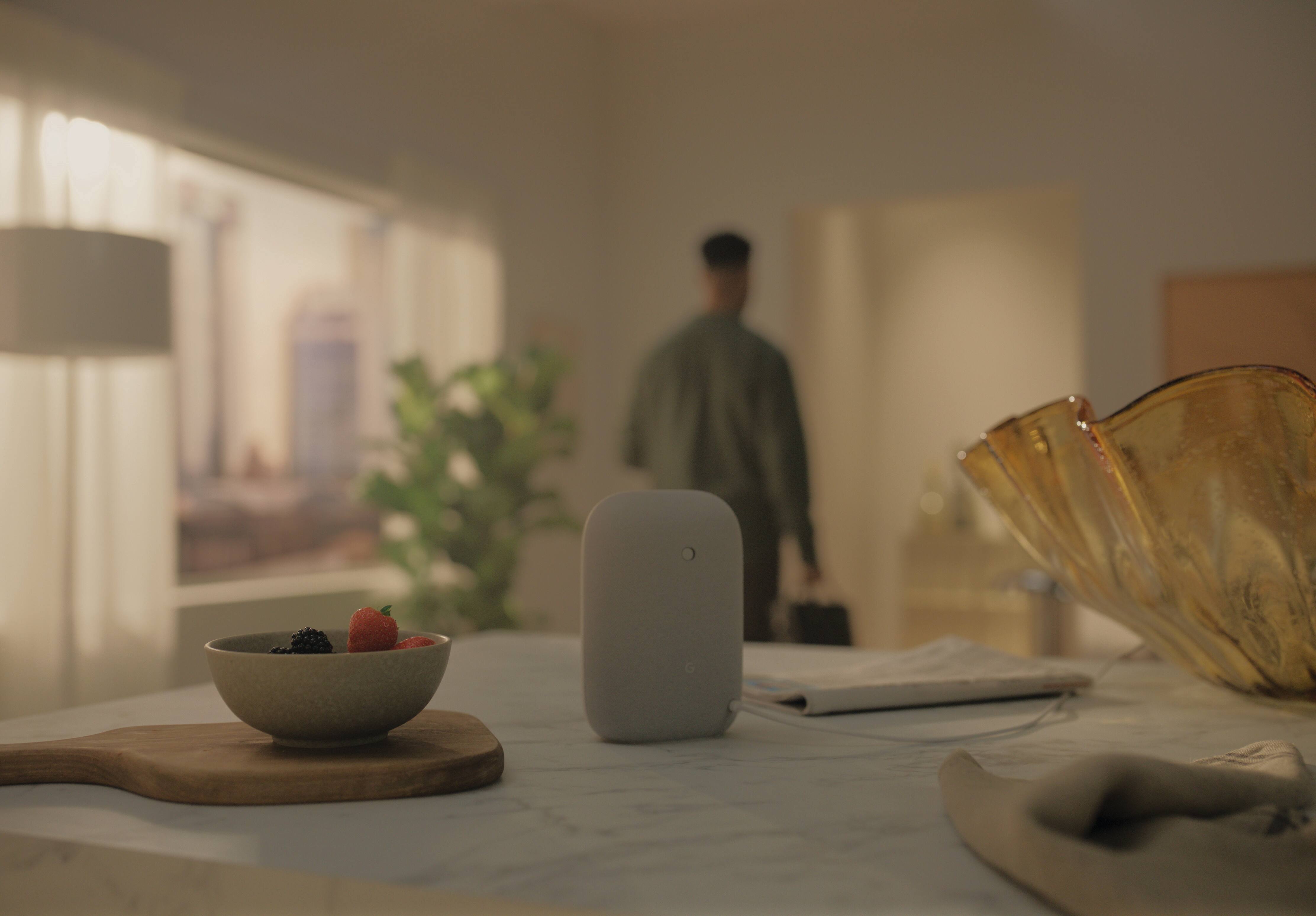 man leaving and in the background the voice assistant device