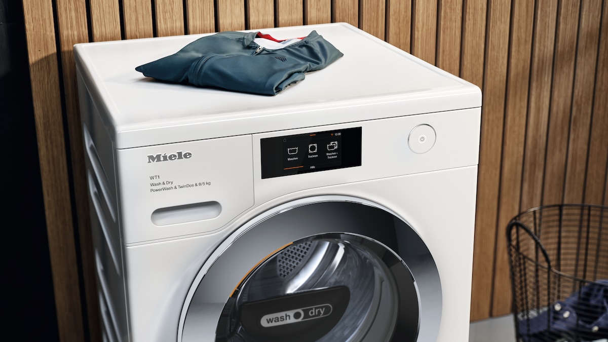 Miele washer dryer with cloths folded on top of it