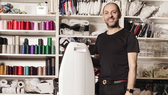 Jason Grech with the Miele Professional Steam Ironing System folded
