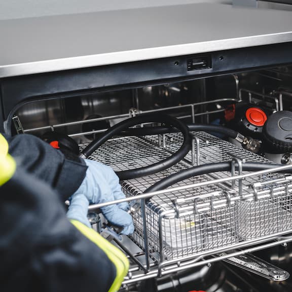 Detailed view of a washer-disinfector with breathing apparatus.
