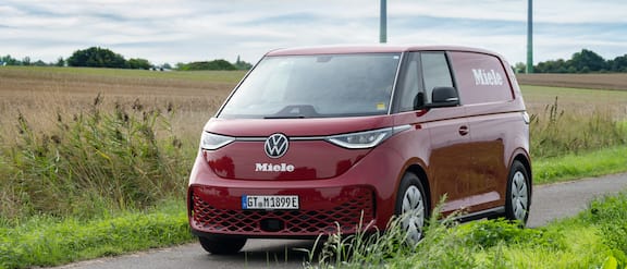 The red Miele Service van on a country road