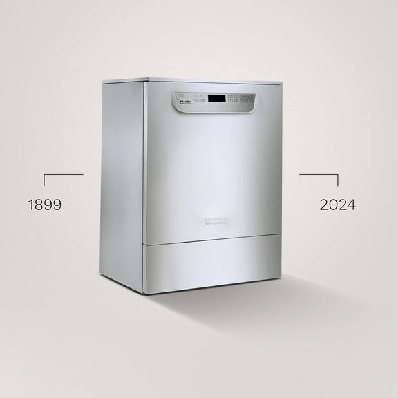 Una lavadora desinfectadora de color acero inoxidable de la serie PG 85 ante un fondo gris.