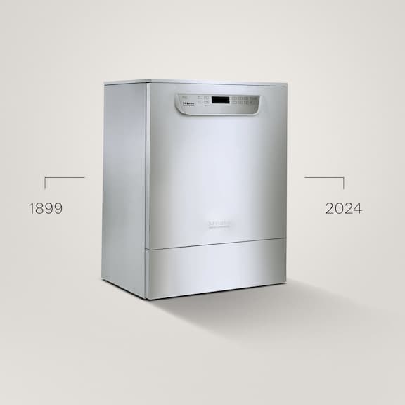 A stainless steel-coloured washer-disinfector from the PG 85 series is placed on a grey background.