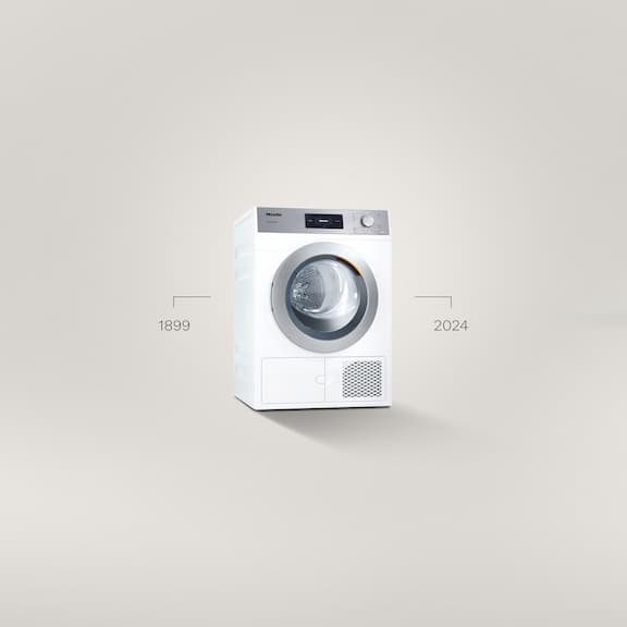 Eine Kleine Riesen Performance Plus Waschmaschine steht vor einem grauen Hintergrund