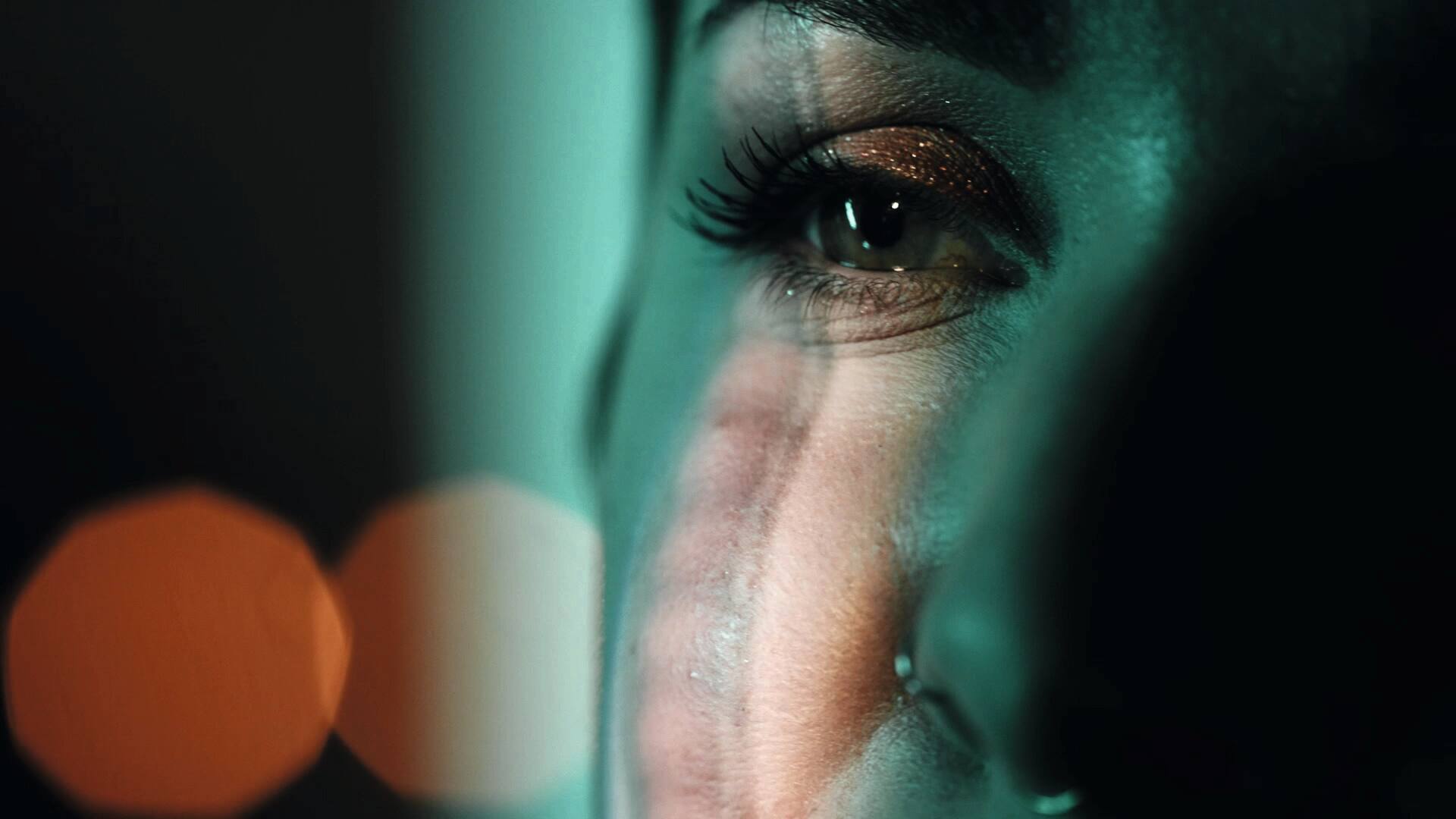 Woman's eye with green light over it