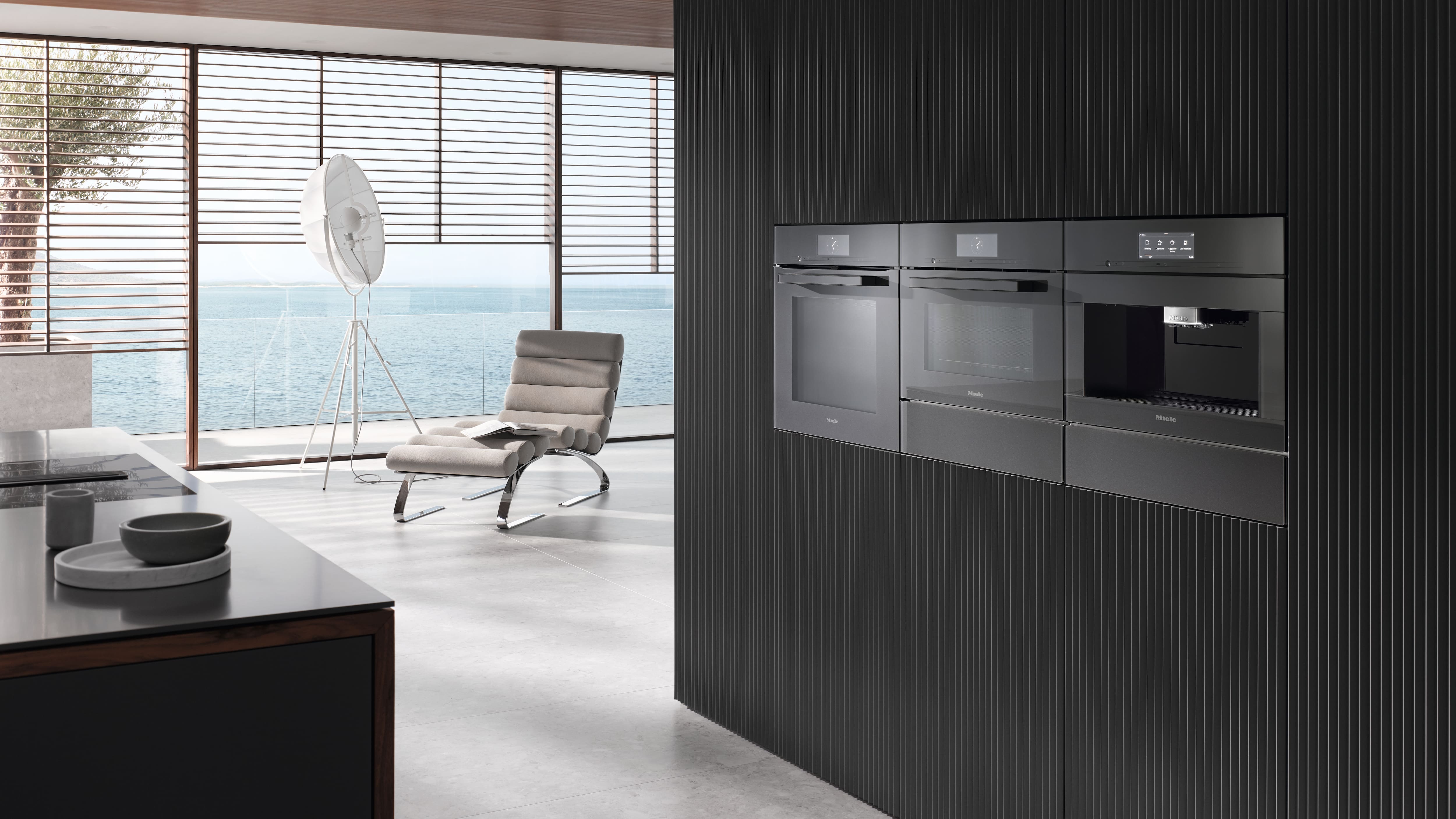 Modern kitchen setting with Miele graphite grey appliances